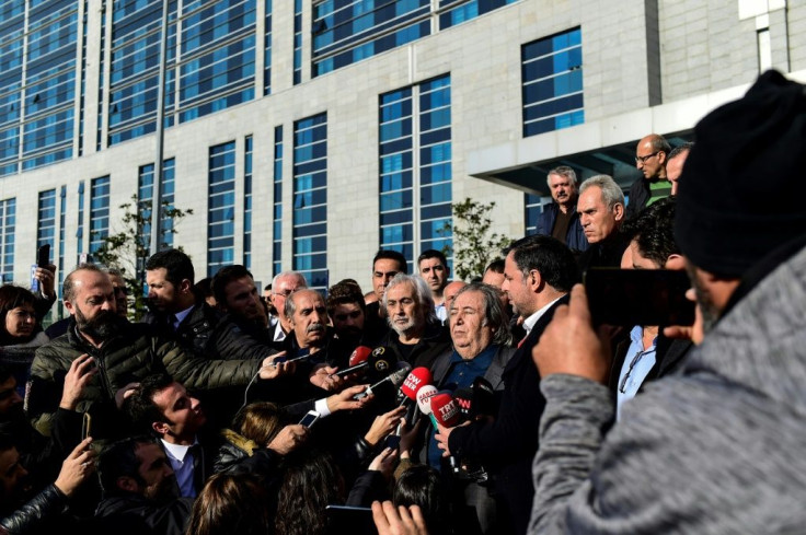 Gezen answers journalists' questions as he leaves a courthouse in Istanbul on December 24, 2018, after a hearing in the case against him for 'insulting' statements against Erdogan