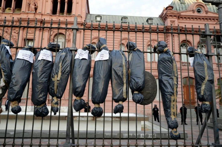 Demonstrators hung mock body bags in front of the Casa Rosada presidential office in Buenos Aires to protest against a scandal over vaccine line-jumping