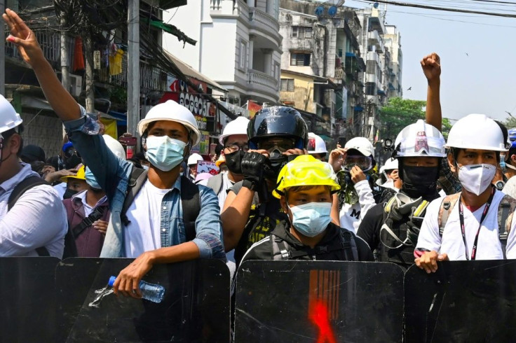 Protesters in Yangon took up positions behind barricades and wielded homemade shields to defend themselves against the onslaught