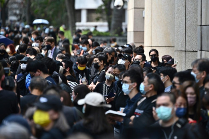 Hundreds of protesters, some chanting slogans including "Release all political prisoners" and "Liberate Hong Kong, revolution of our times", queued up outside the law courts in one of the biggest gatherings in months