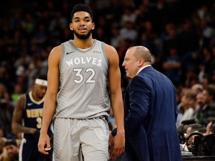 Jimmy Butler #23 of the Minnesota Timberwolves heads to the bench as head coach Tom Thibodeau looks on