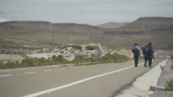 The final stretch on a harsh and sometimes deadly journey by foot to Santiago: Venezuelan migrants trek on a mountain road crossing the high-altitude Chilean Altiplano and the Atacama Desert, considered the driest place on Earth.