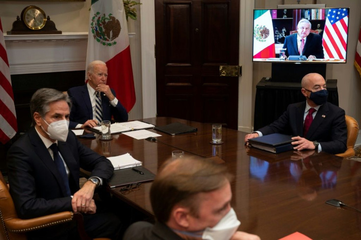 US President Joe Biden (C), flanked by US Secretary of State Antony Blinken (L) and US Secretary of Homeland Security Alejandro Mayorkas (R), meets virtually with Mexican President Andres Manuel Lopez Obrador
