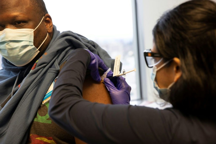 Dr Stephaun Wallace, who leads the global external relations strategies COVID-19 Prevention Network at the Fred Hutchinson Cancer Research Center, receives his second injection from Dr. Tia Babu during the Novavax Covid-19 vaccine phase 3 clinical trial a