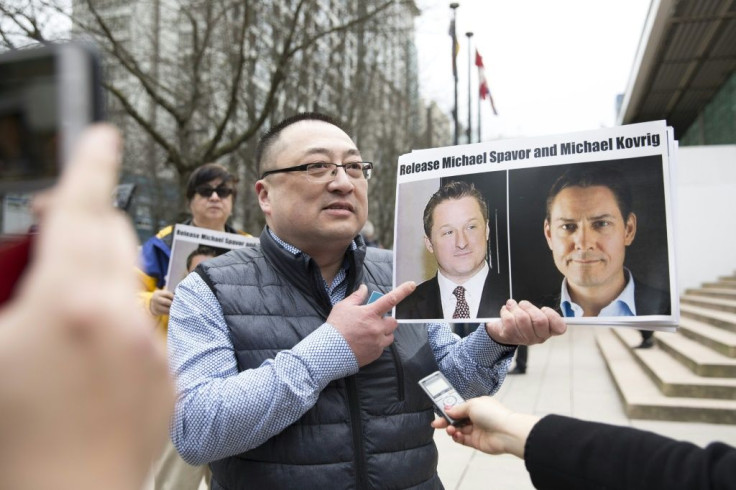 Protesters in March 2019 outside the Vancouver courthouse held photos of Michael Spavor (L) and Michael Kovrig (R) held by China in apparent retaliation for Huawei executive Meng Wanzhou's arrest