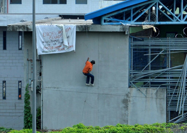An inmate escapes a pavilion at the prison in Guayaquil, Ecuador, on February 25, 2021, during a riot