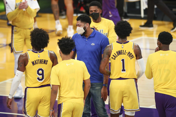 Anthony Davis #3 of the Los Angeles Lakers talks with teammates Wesley Matthews #9 and Kentavious Caldwell-Pope #1