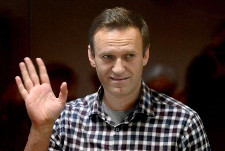 Russian opposition leader Alexei Navalny stands inside a glass cell during a court hearing in Moscow on February 20, 2021