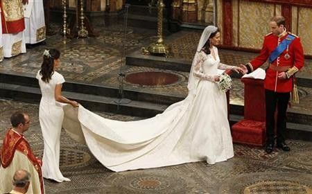 Maid of Honour, Pippa Middleton L holds the wedding dress of her sister Catherine, Duchess of Cambridge, after her she married Britain039s Prince William