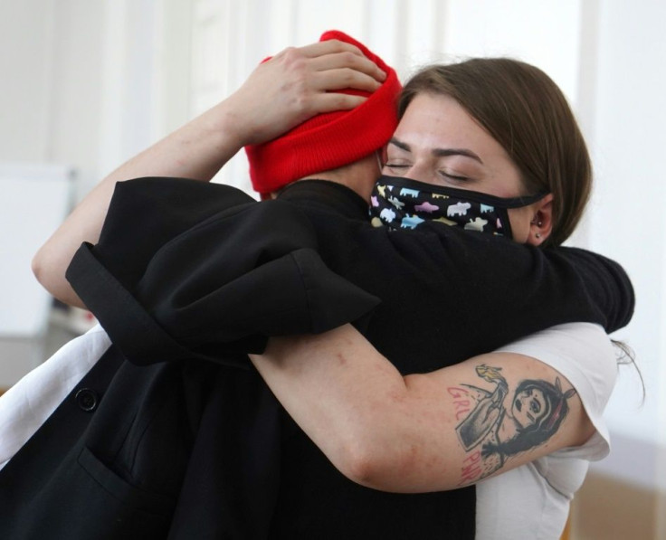 Defendant Anna Prus, right, reacts to the acquittal of herself and two other gay rights activists in the Polish court