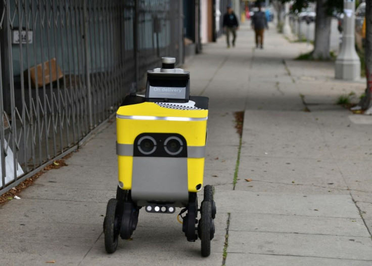 A Postmates robot brings food to customers in Los Angeles -- the robotics division of Postmates, acquired by Uber last year, will be spun out as an independent company