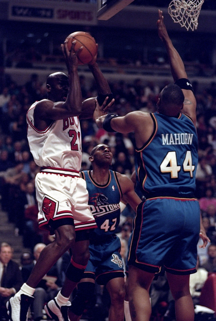 Michael Jordan of the Chicago Bulls (left) in action against guard Jerry Stackhouse (center) and forward Rick Mahorn of the Detroit Pistons