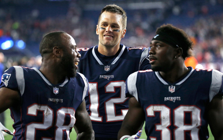 Tom Brady #12 of the New England Patriots celebrates with James White #28 and Kenjon Barner #38 of the New England Patriots