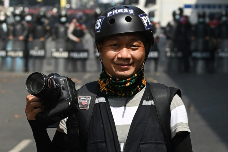 Associated Press (AP) photographer Thein Zaw posing for a photo during his coverage of demonstrations by protesters against the military coup in Yangon, a day before he was arrested