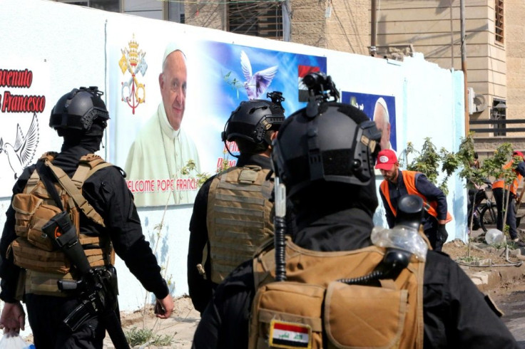 Iraqi security forces patrol around the Cathedral of Saint Joseph during preparations for the Pope's visit in Iraq's capital Baghdad