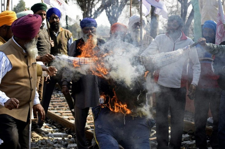 Farmers shout slogans as they burn an effigy of Indian Prime Minister Narendra Modi during a protest against agricultural reforms on the outskirts of Amritsar on February 5, 2021