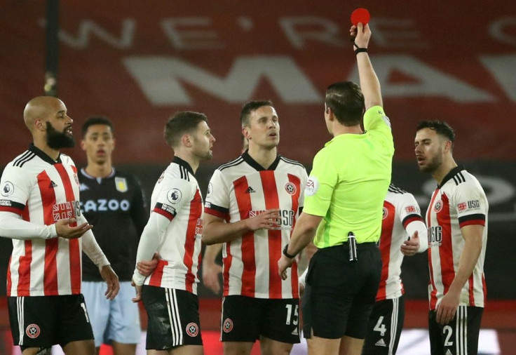 Perfect 10 men: Phil Jagielka's (centre) red card did not cost Sheffield United