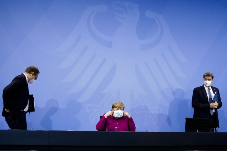 German Chancellor Angela Merkel (C), Bavaria's State Premier Markus Soeder (R) and Berlin's Mayor Michael Mueller leave following talks with Germany's state premiers on the extension of the current Covid-19 restrictions in Berlin March 4, 2021