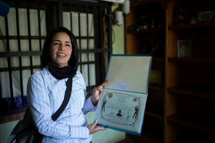 Ismaira Figueroa, a sniper for the Bolivarian militia in Venezuela, keeps a folder with her diplomas, including a sheet of paper with six holes in it that confirmed her graduation as an "expert marksman" in 2016