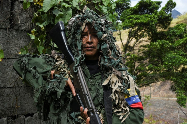 Ismaira Figueroa, a sniper for the Bolivarian militia, carries a Belgian-made 7.62 mm caliber FAL rifle while taking part in military exercises in Caracas