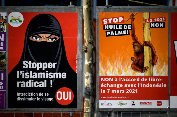 Campaign posters reading "Stop radical Islam!" and "Stop extremism!", featuring a woman in a black niqab, have been plastered around Swiss cities