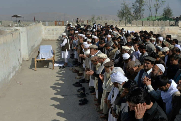Relatives and mourners perform funeral prayers over the coffin of a female media worker shot dead in Jalalabad this week
