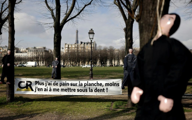 Inflatable dolls were hung outside parliament in Paris on Thursday to draw attention to farmers' problems.