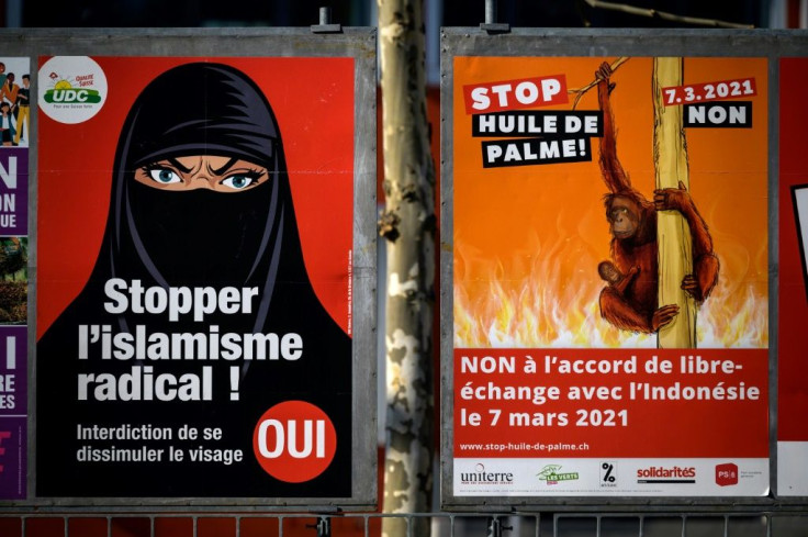 The poster on the right urges Swiss voters to reject a free trade agreement with Indonesia, portraying an orangutan in peril