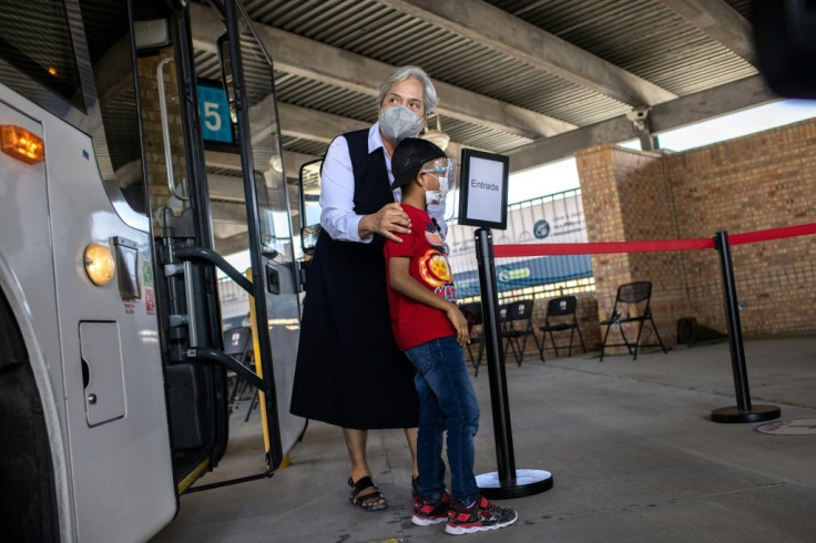 Sister Norma Pimentel of Catholic Charities escorts a child who has requested asylum upon arriving in the United States on February 26, 2021 in Brownsville, Texas