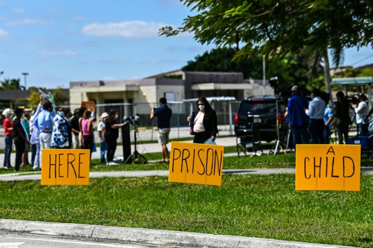 Demonstrators call for an end to the detention of unaccompanied minors arriving in the United States, outside a facility in Homestead, Florida previously used to hold undocumented children, on March 4, 2021
