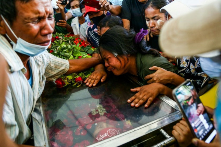 The wife of Phoe Chit, a protester who died during a demonstration against the military coup, cries over the coffin of her husband during his funeral in Yangon on March 5, 2021