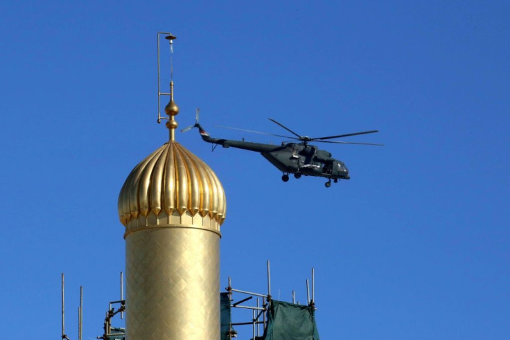 An Iraqi military helicopter flies over the Imam Ali mausoleum in Najaf as authorities lay on tight security in the shrine city for a landmark meeting between Pope Francis and top Shiite cleric Grand Ayatollah Ali Sistani