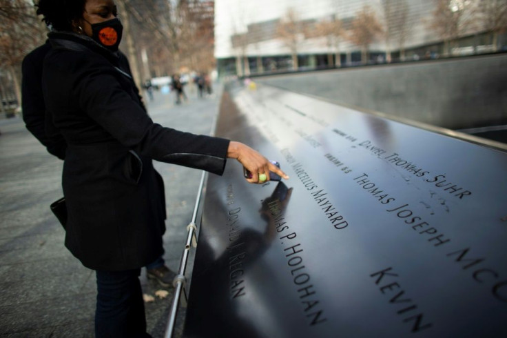 Janice Ryan pointing at the name of her friend who died in 9/11