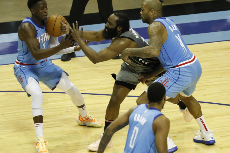 James Harden #13 of the Brooklyn Nets loses the ball as he is pressured by P.J. Tucker #17 of the Houston Rockets and Victor Oladipo #7