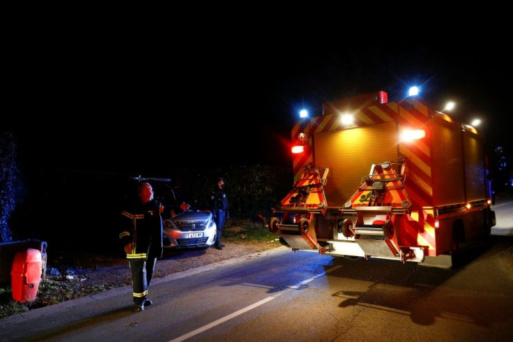Emergency workers arrive at the scene of a helicopter crash in northwest France in which Olivier Dassault died