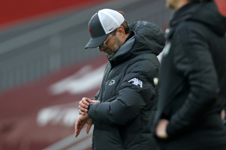 Problems for Liverpool manager Jurgen Klopp who checks his watch in the defeat against Fulham