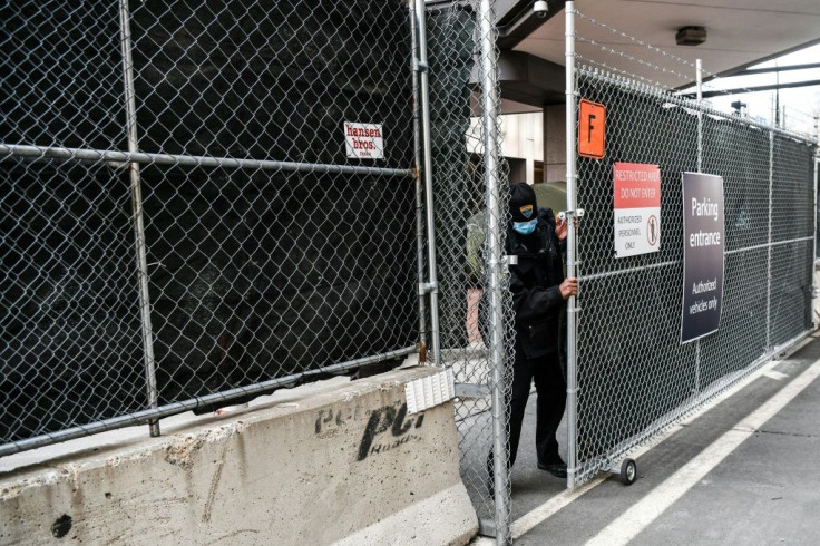 Law enforcement officers lock a barricade on March 7, 2021, outside the Hennepin County Government Center in Minneapolis, Minnesota a day before the start of the trial of a former police officer charged with murdering George Floyd, a Black man