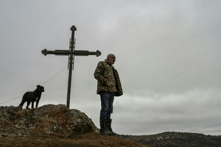 A resident of Shurnukh village looks towards an Azeri military camp now based in the village