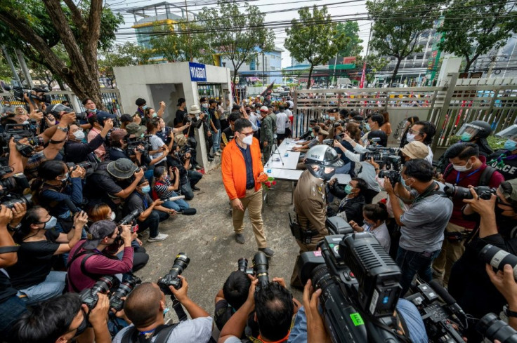 The activists marched to a Bangkok criminal court Monday morning flanked by scores of supporters carrying posters of other detained protest leaders and flags