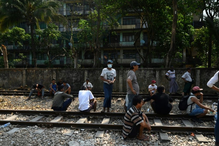Myanmar railway staff gather by the tracks as security forces arrive at Ma Hlwa Gone station to arrest workers on strike to protest against the coup