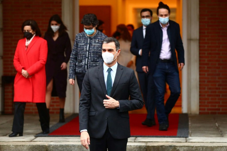 Prime Minister Pedro Sanchez (C) and his ministers arrive for their weekly cabinet meeting in Madrid