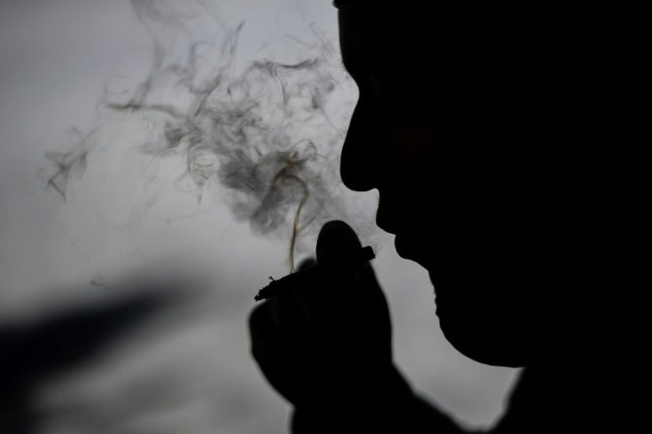 A man smokes a joint in Mexico City, where lawmakers are preparing to vote on the legalization of recreational marijuana use