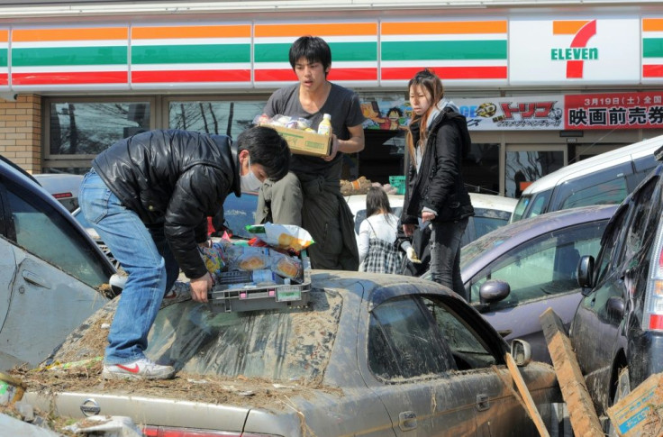 Residents carry outside a shop in Miyagi prefecture, two days after the tsunami hit