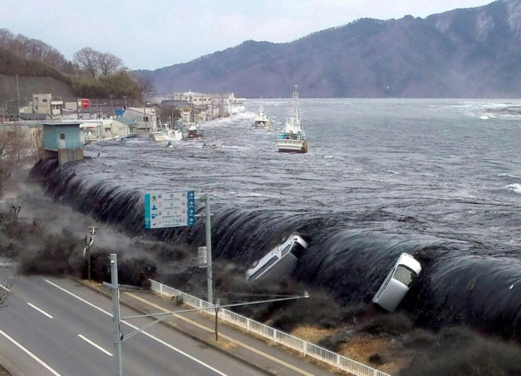 Huge waves breach an embankment in the city of Miyako in Iwate prefecture, in the wake of the earthquake on March 11, 2011