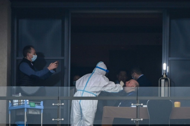 The World Health Organization (WHO) team investigating the origins of the pandemic, seen here giving swab samples after arriving in Wuhan, were accused of allowing China t odictate the parameters of their mission