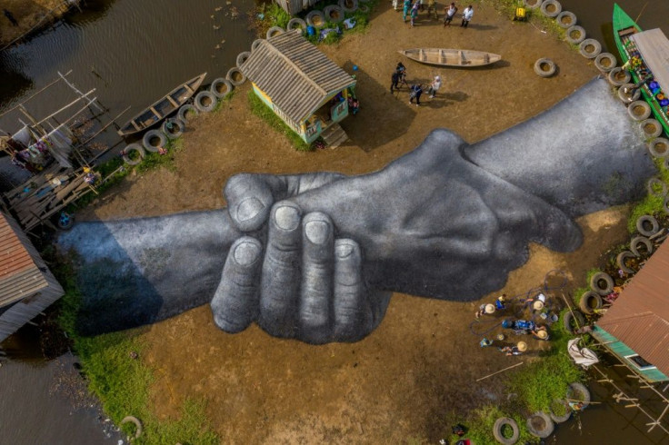 Guillaume Legros, also known as Sype, painted vast joined hands in Benin as part of a chain of similar works around the world