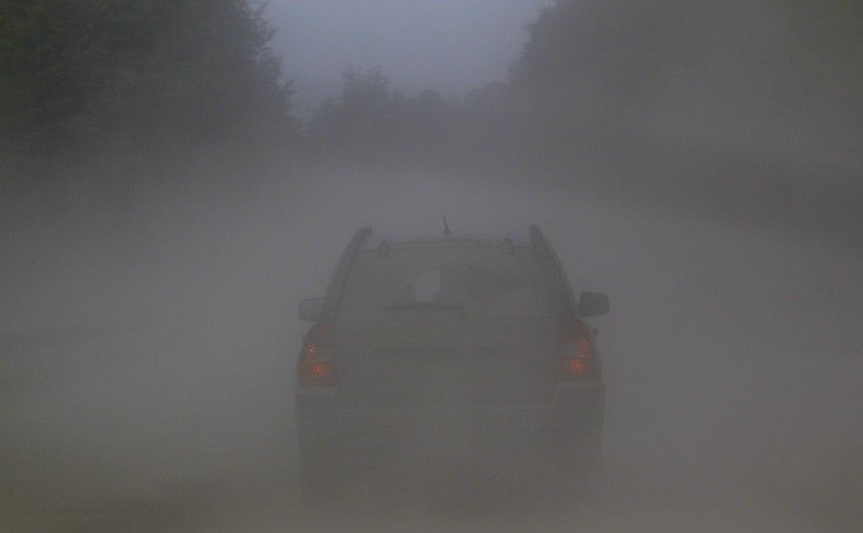 A car travels along a road covered with ashes near the erupting Puyehue volcano near Argentina039s border.
