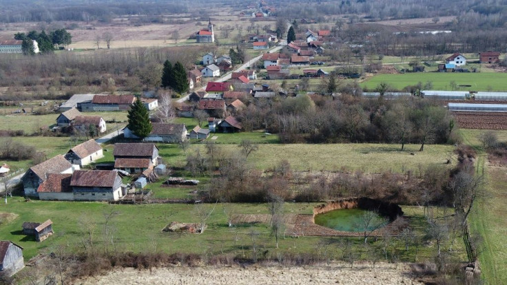 Many of the holes have filled with emerald-coloured groundwater