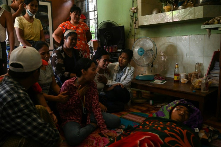 Family members mourn Myanmar protester Chit Min Thu who was shot in the head by security forces while demonstrating against the military coup in Yangon on March 11