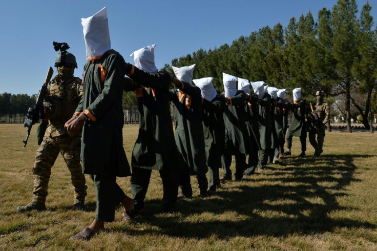Afghan security forces escort suspected Taliban fighters